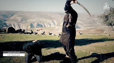 See the Heart Broken Pictures Of A 6-Year-Old Boy Assists ISIS Executioner In Beheading Two Prisoners [Graphic Photos]