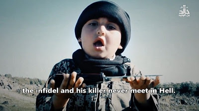 See the Heart Broken Pictures Of A 6-Year-Old Boy Assists ISIS Executioner In Beheading Two Prisoners [Graphic Photos]