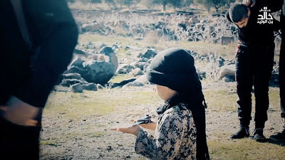 See the Heart Broken Pictures Of A 6-Year-Old Boy Assists ISIS Executioner In Beheading Two Prisoners [Graphic Photos]
