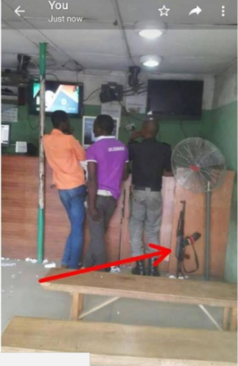 Viral Photo Of Nigerian Police Officer, Drops His Riffle To Play Bet9ja