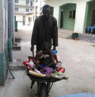 Man Takes Son To Hospital In Wheelbarrow In Imo State After Waiting Hours But No Available Vehicle [Photos]