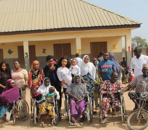 Tonto Dikeh All Smiles As She Carries Crippled Woman During Visit To Physically Challenged People In Abuja 