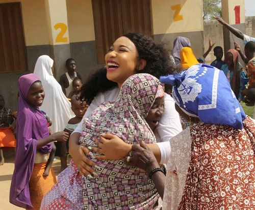 Tonto Dikeh All Smiles As She Carries Crippled Woman During Visit To Physically Challenged People In Abuja 