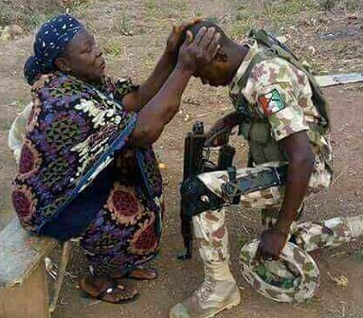 Heart Melting Photo of a Nigerian Mum Praying for Her Soldier Son, As He Goes to Fight Boko Haram in The Northeast