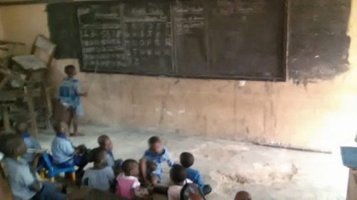 Heart Melting Photos Of Pupils Taking Lessons On Bare Floor In A Community That Hosts 6 Oil Wells In Delta
