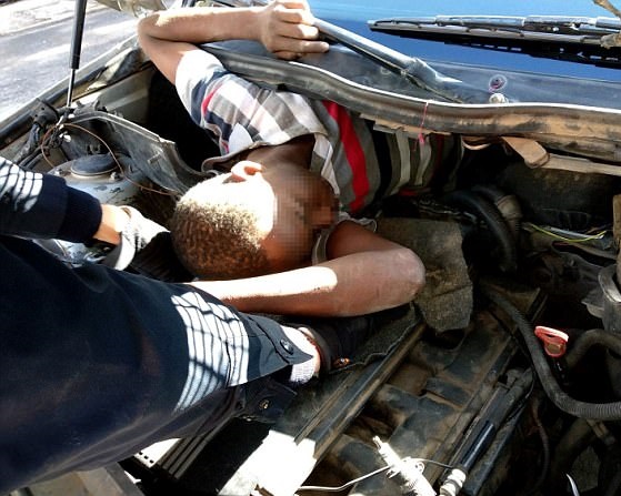 Photos Of Four Suspected Migrants Caught While Hiding Under Car Bonnet To Sneak Into Europe