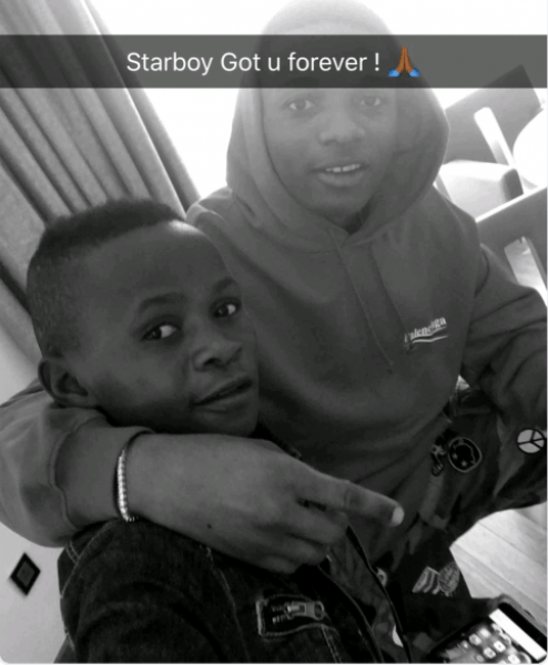 Wizkid Shares New Photos with Little Boy He Recently Signed At His Concert