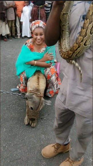 Photos Of Young Pretty Lady Posing With Huge Python And Hyena In Kaduna State [Photos]