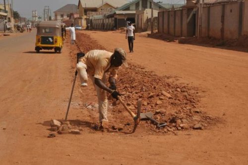 #NigerianYouthsAreNotLazy – Nigerian Guy Says As He Post Photos Of One-legged Man Seen Carrying Out Road Construction