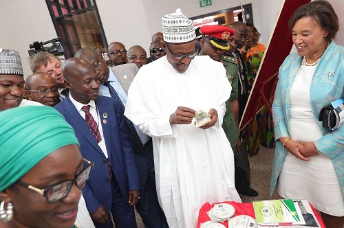 Buhari spotted Counting ‘Looted’ Dollars as He Commissions New EFCC Office in Abuja
