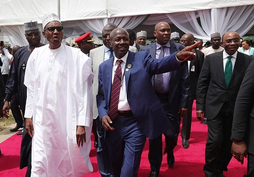 Buhari spotted Counting ‘Looted’ Dollars as He Commissions New EFCC Office in Abuja