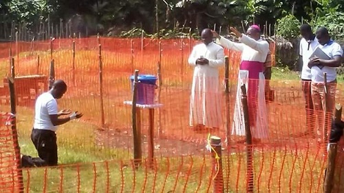 Heart Melting Photo Of Catholic Priest Infected With Ebola Being Prayed For By His Bishop