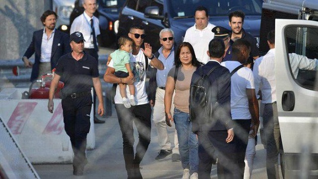 Photos Of King RONALDO As He Lands In Turin With His Girlfriend Ahead Of First JUVENTUS Training [Photos]