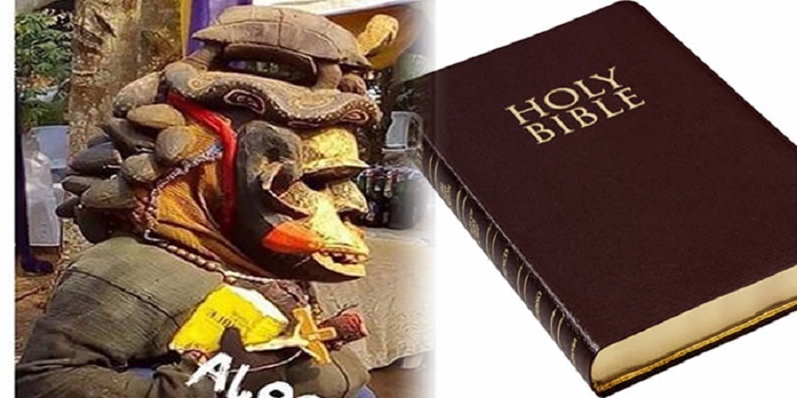 Photos of Masquerade As He Steps Out With His Bible and Crucifix in Anambra State