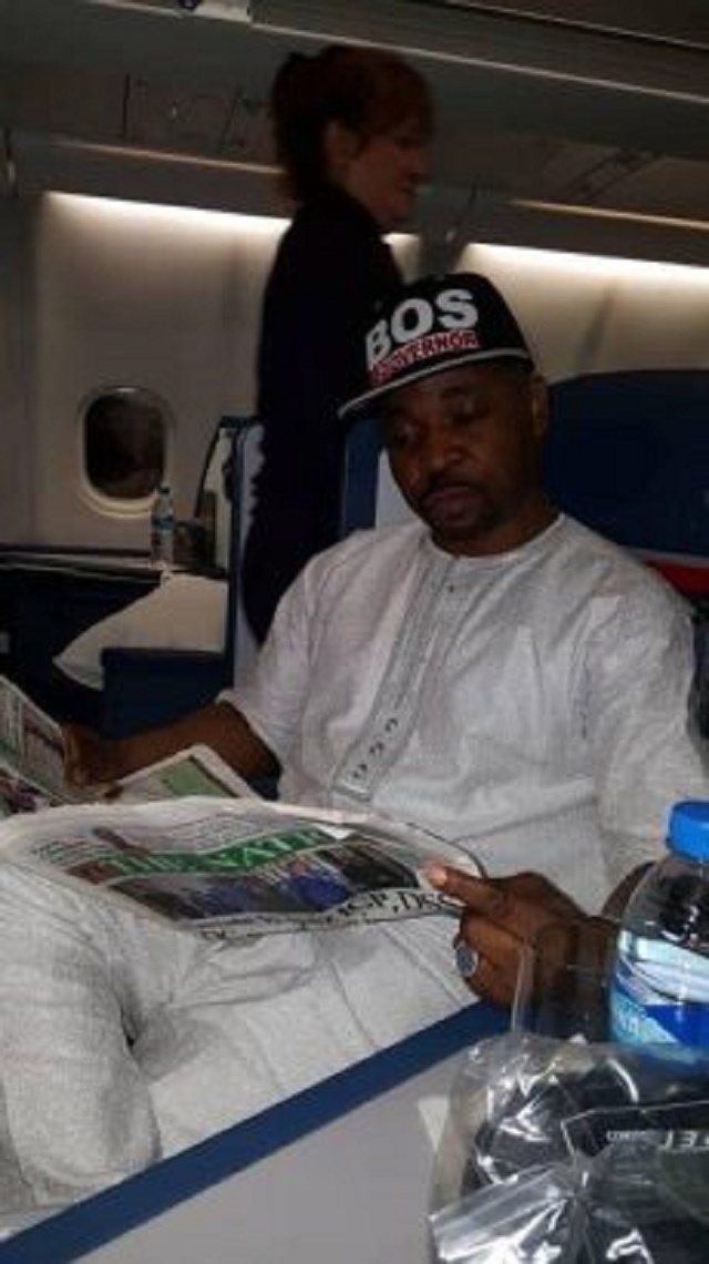 Photos of MC Oluomo On Board a Plane to United States after Getting Stabbed
