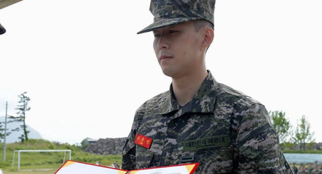 This handout photo taken on May 8, 2020 and published on the official Facebook page of the Republic of Korea Marine Corps shows Tottenham Hotspur’s South Korean striker Son Heung-min in military uniform receiving a prize during a basic military training completion ceremony at a marines boot camp in Jeju island. Tottenham Hotspur striker Son Heung-min was named one of the top five recruits in his unit as he finished three weeks of compulsory military training in South Korea on May 8. Handout / Republic of Korea Marine Corps / AFP