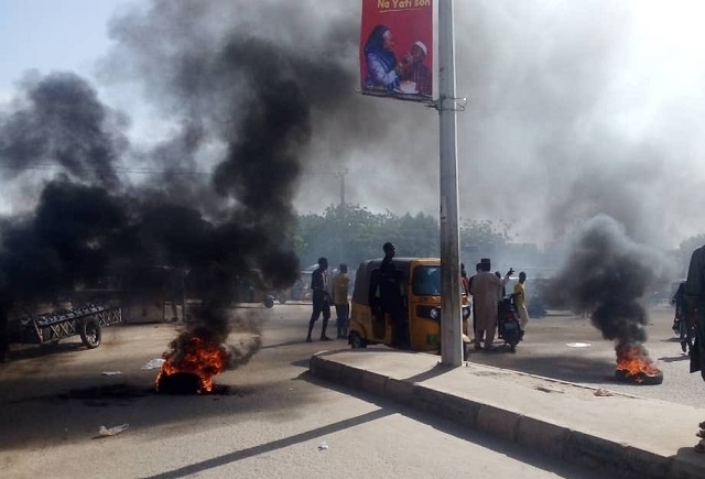 Protest Erupts In Kano over the Death of 17-Year-Old Boy in Police Custody There is reportedly an ongoing protest in Kano state following the death of a 17-year-old boy identified simply as Saifullah in police custody.  According to Amnesty International, it was alleged that Saifullah was tortured to death by the police. It was further learnt that protesters have barricaded the main Kofar Mata road and set tyres on fire, chanting songs calling for an end to police brutality.  Read the tweets below; 
