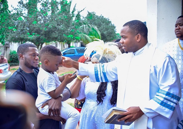 “My Son Pulled Up To the House Of God for Baptism on All White” – Cubana Chief Priest Says As Son Undergoes Water Baptism (PHOTOS)